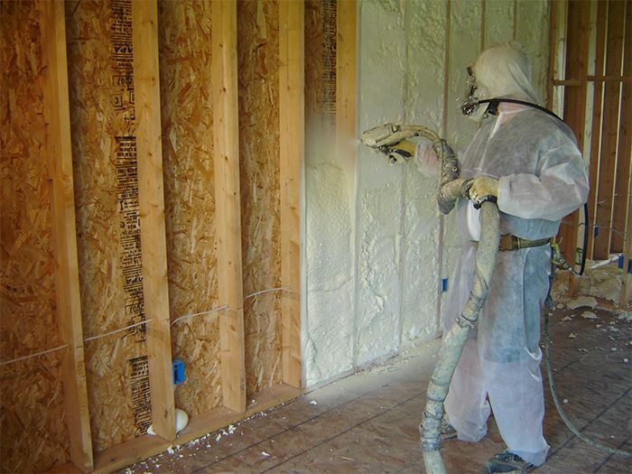 open cell spray foam insulation being applied