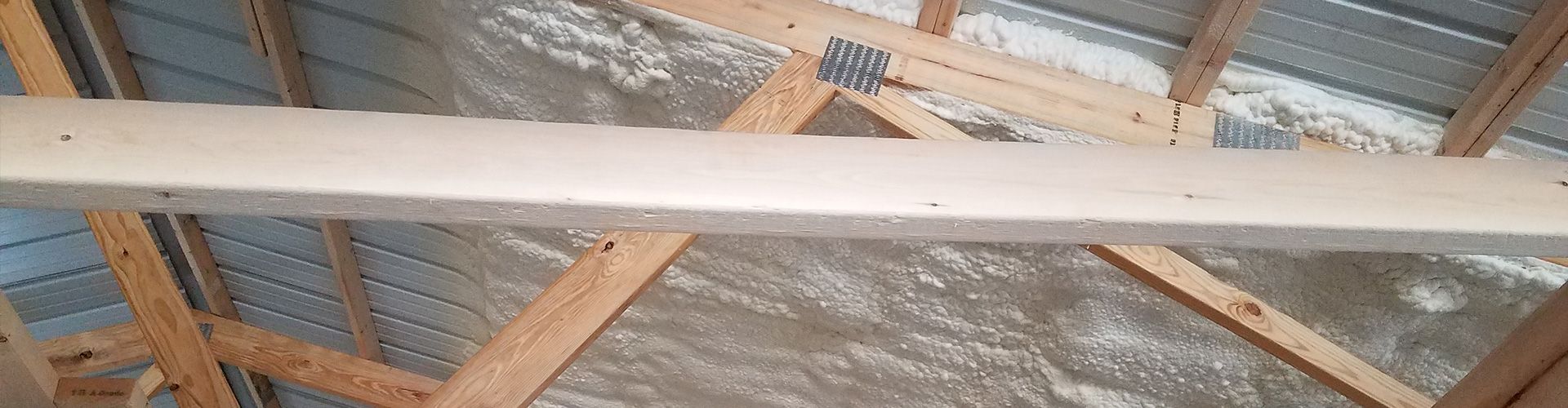 applying spray foam insulation to a pole barn