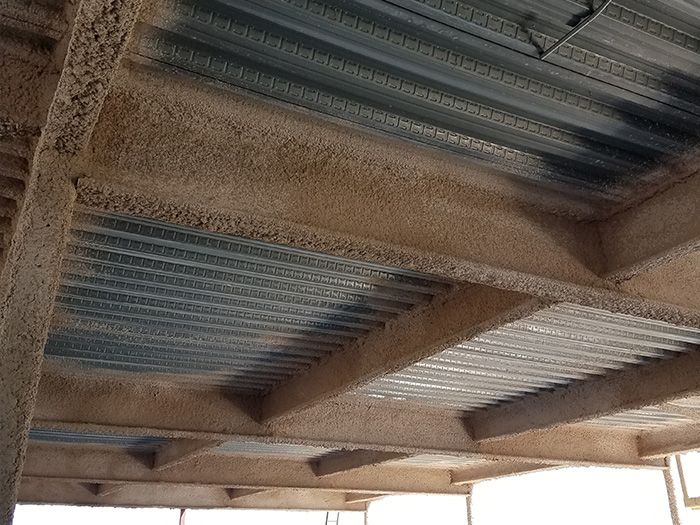 spray applied fireproofing on a metal ceiling