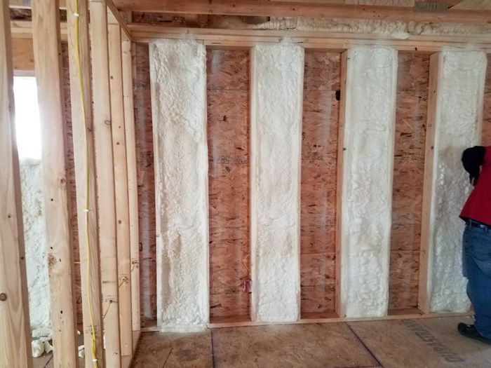 spray foam insulation being applied to a wall